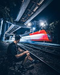 Side view of train at railroad station at night