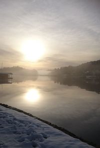 Scenic view of frozen lake against sky during sunset