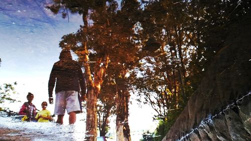 Woman standing on tree trunk