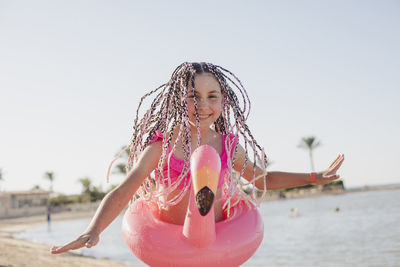 Happy girl with braided hair enjoying on beach