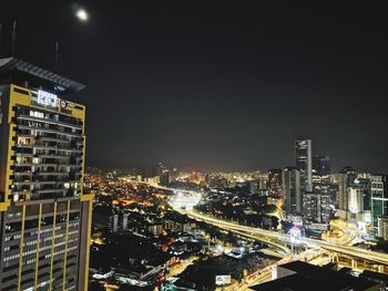 High angle view of illuminated buildings in city at night