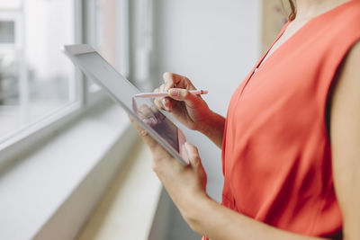 Midsection of woman using mobile phone