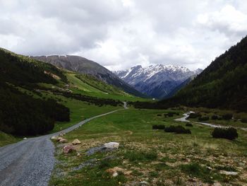 Scenic view of mountains against cloudy sky