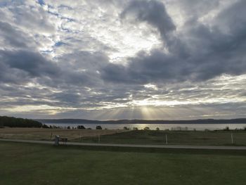 Scenic view of field against sky at sunset