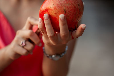 Midsection of woman holding fruit