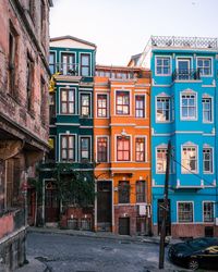 Houses by street against sky in city