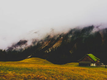 Scenic view of field against sky during foggy weather