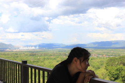 Portrait of beautiful woman against sky