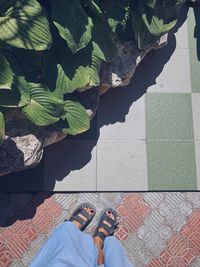 Low section of woman standing by swimming pool