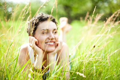 Portrait of a cute girl on green field