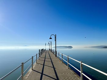 Scenic view of sea against clear blue sky