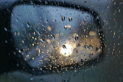 Waterdrops on glass against rear view mirror