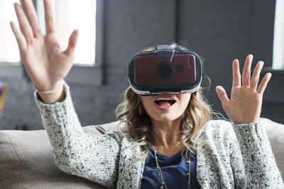 Businesswoman wearing virtual reality simulator in office