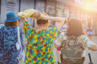 Rear view of women walking in city