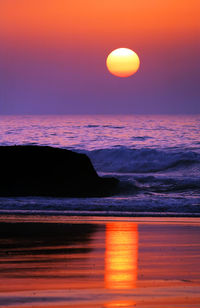 Scenic view of sea against orange sky