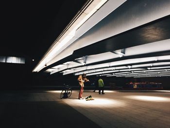 People on illuminated footpath 