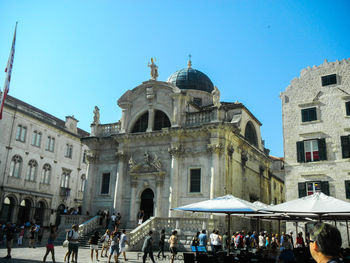 People in temple against clear sky