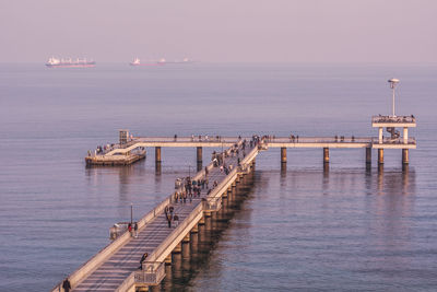 High angle view of people on pier over sea