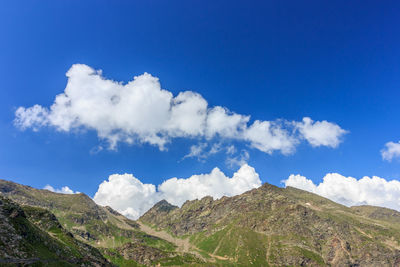 Low angle view of clouds over mountain