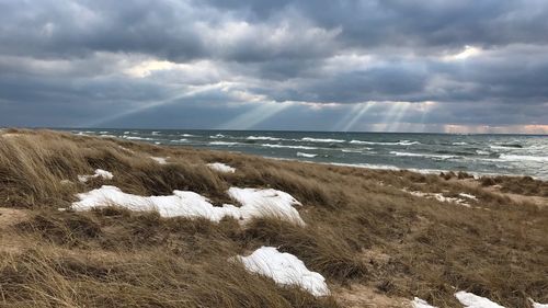 Scenic view of sea against storm clouds