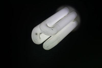 Close-up of light bulb against black background