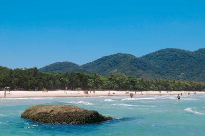 View of beach against mountains