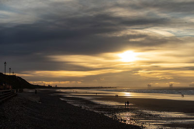 Scenic view of beach against sky during sunset