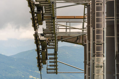 The details of a new ski lift, cable way. support pole, rope, wheels, steps, steel construction.