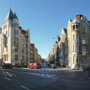 Vehicles on road along buildings