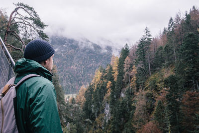 Man standing by plants on mountain during winter