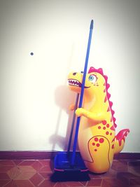Close-up of toy on table against wall