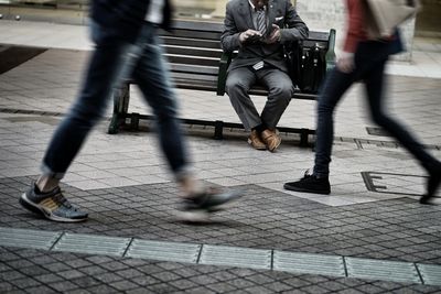 Low section of people walking on footpath