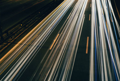 High angle view of light trails on highway at night