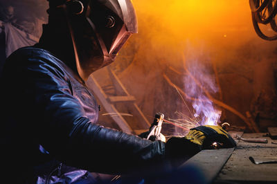 Midsection of man welding metal