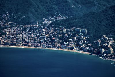 High angle view of sea and buildings in city