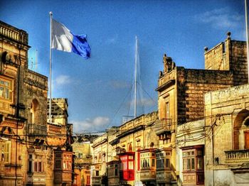 Low angle view of buildings against blue sky