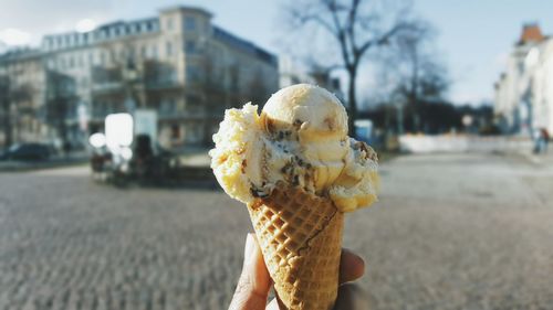 Close-up of hand holding ice cream cone