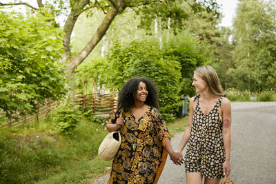 Two young women holding hands