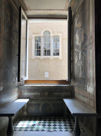 Empty chairs and table in building