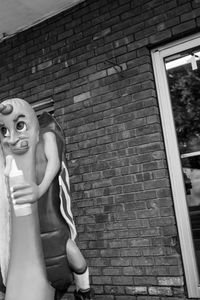 Midsection of man against brick wall