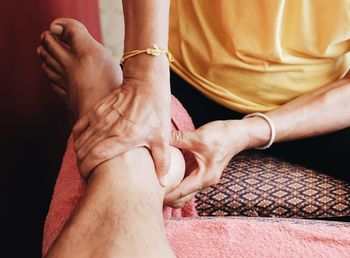 Midsection of couple holding hands