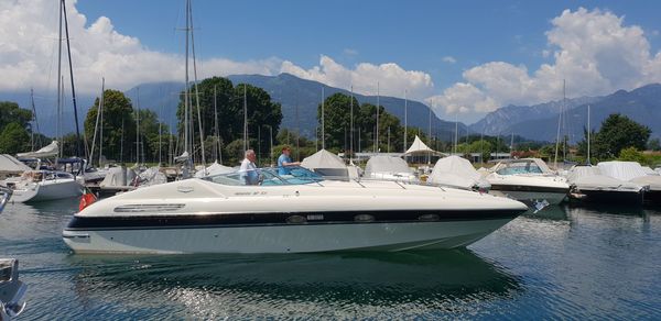 Panoramic view of sailboats moored on shore against sky