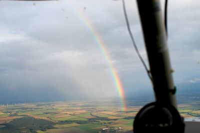 Rainbow over landscape against sky