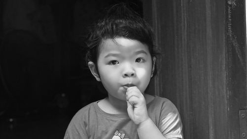 Portrait of cute girl sucking candy