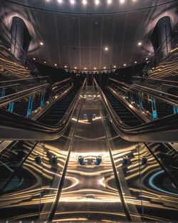 Low angle view of illuminated escalators