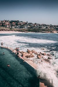 High angle view of sea and buildings against sky