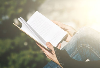 Low section of person holding book