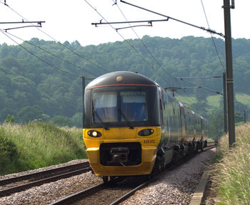 Train on railroad track against clear sky