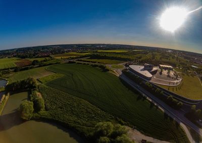 Aerial view of road amidst field against sky