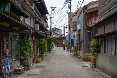 Road amidst buildings against sky